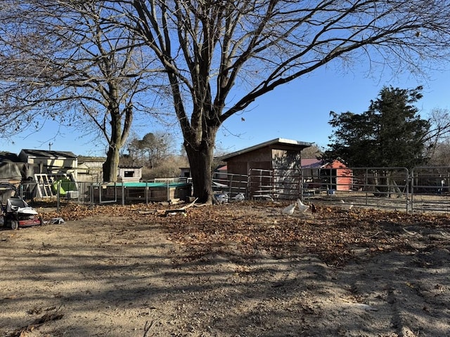 view of yard featuring an outbuilding and fence