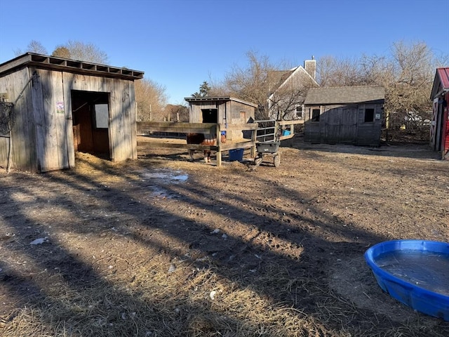 view of yard with an outbuilding and a storage unit