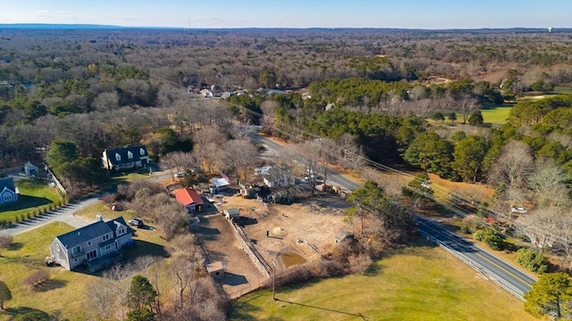 birds eye view of property featuring a forest view