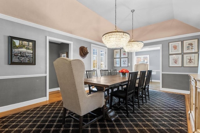 dining room featuring crown molding, lofted ceiling, dark hardwood / wood-style floors, and a chandelier