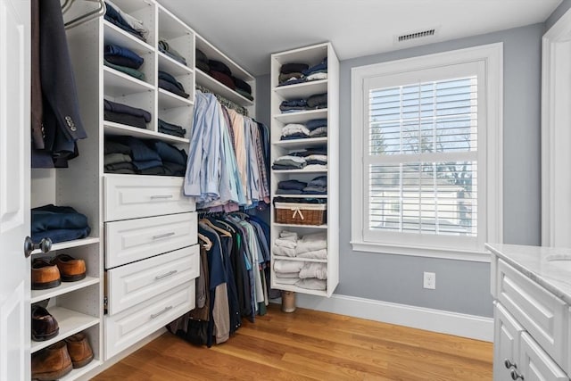 walk in closet with light wood-type flooring