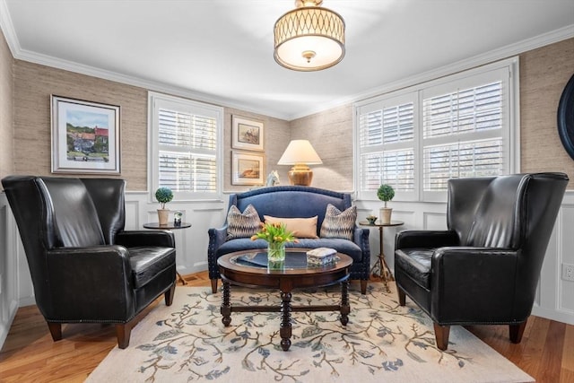 living area featuring crown molding and light wood-type flooring