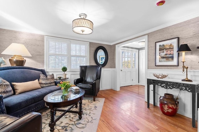 living room featuring ornamental molding and light wood-type flooring