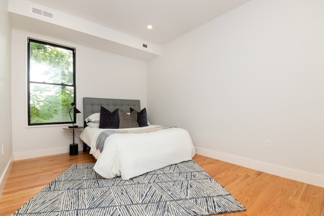 bedroom with wood-type flooring