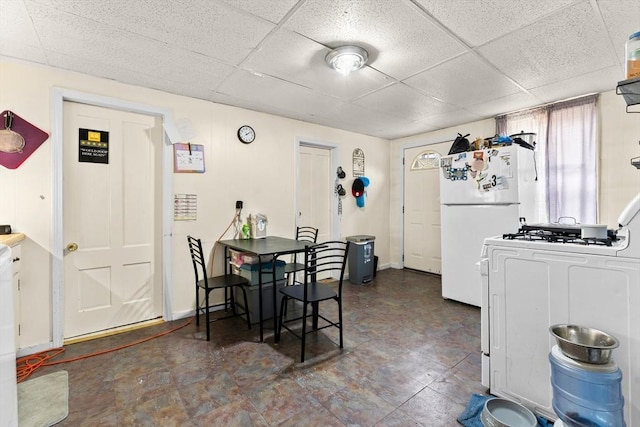 dining area with baseboards and a paneled ceiling