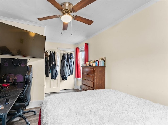 bedroom with crown molding, ceiling fan, and wood finished floors