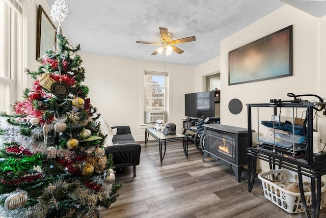 living area with ceiling fan and wood finished floors