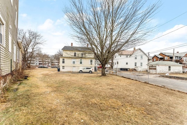 view of yard with a residential view and fence