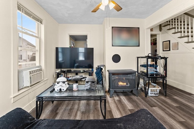 living room featuring stairs, a ceiling fan, baseboards, and wood finished floors