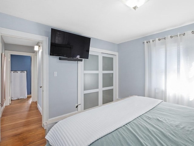 bedroom with wood finished floors and baseboards