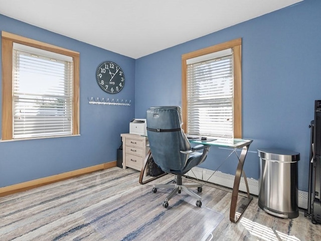 office area with baseboards and wood finished floors