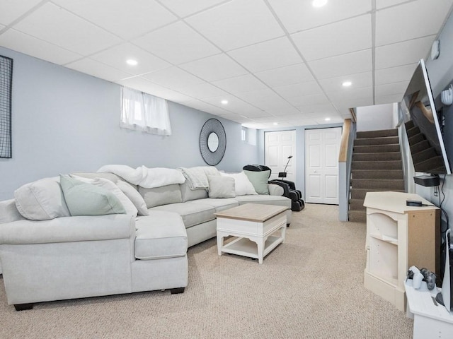 living area featuring stairs, carpet floors, a drop ceiling, and recessed lighting