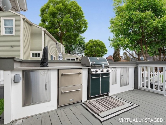 wooden terrace featuring an outdoor kitchen