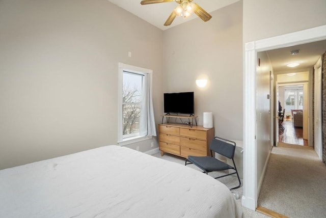 6 Brigham St Unit 2, Boston, MA 02128 - bedroom with light colored carpet, baseboards, high vaulted ceiling, and a ceiling fan