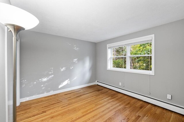 11 Cogswell Ave Unit 16, Cambridge, MA 02140 - empty room with baseboard heating, light wood-type flooring, and baseboards