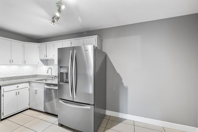 11 Cogswell Ave Unit 16, Cambridge, MA 02140 - kitchen with stainless steel appliances, a sink, light tile patterned floors, and white cabinets
