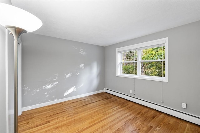 11 Cogswell Ave Unit 16, Cambridge, MA 02140 - spare room with a baseboard radiator, light wood finished floors, and baseboards