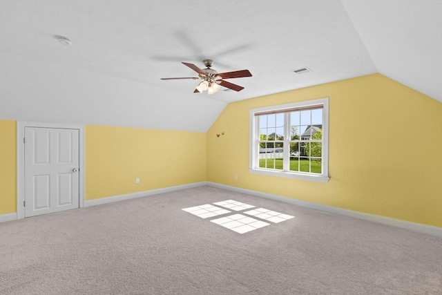 additional living space with vaulted ceiling, ceiling fan, carpet flooring, and baseboards