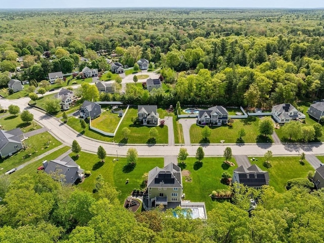 aerial perspective of suburban area with a forest