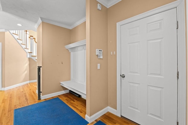 mudroom with ornamental molding, wood finished floors, baseboards, and recessed lighting