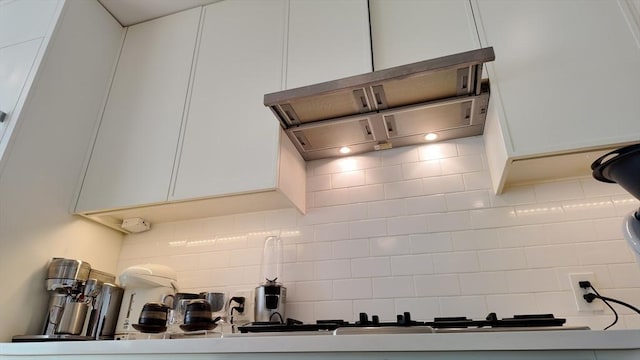 kitchen featuring decorative backsplash and white cabinets