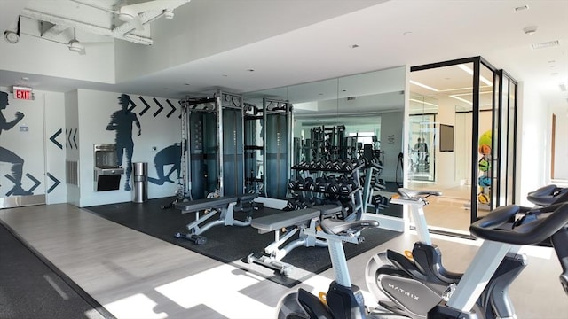 exercise room with wood-type flooring