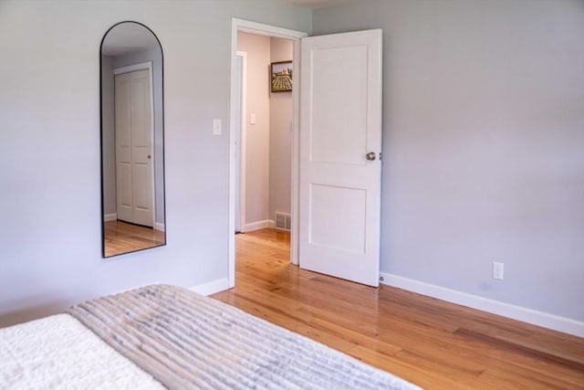 62 Roberts Dr Unit 62, Bedford, MA 01730 - unfurnished bedroom featuring light wood-type flooring, baseboards, and arched walkways