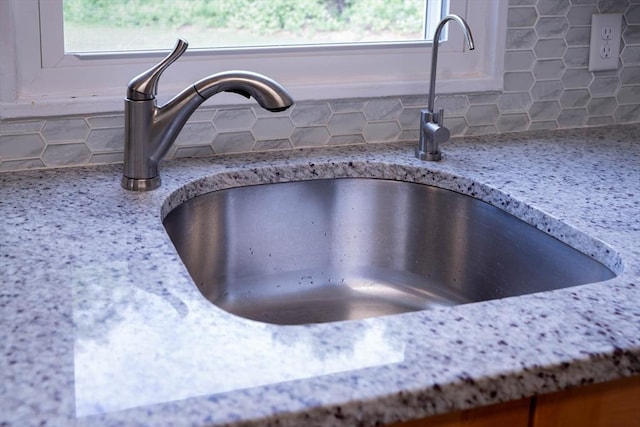 62 Roberts Dr Unit 62, Bedford, MA 01730 - kitchen view of a sink, backsplash, and light stone counters