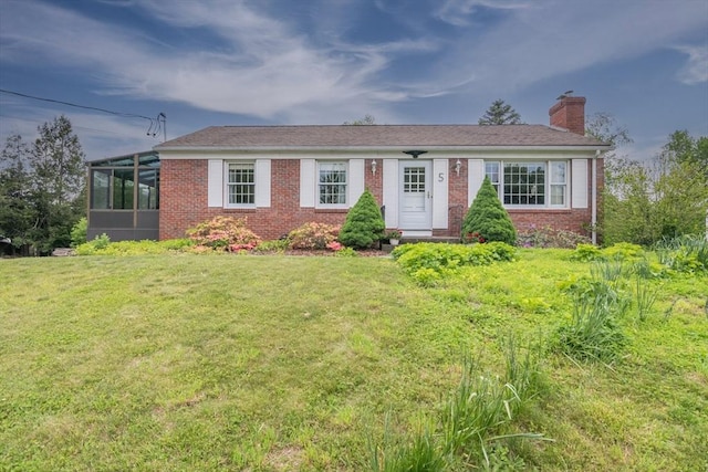 5 Norman Cir, Montague, MA 01376 - single story home featuring a chimney, brick siding, a front lawn, and a sunroom