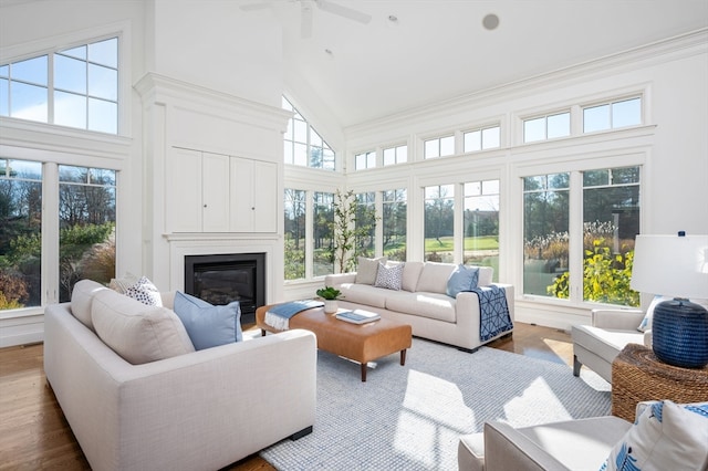 sunroom with vaulted ceiling, a wealth of natural light, and ceiling fan