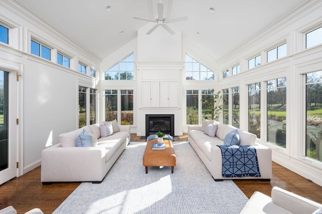 sunroom featuring plenty of natural light, ceiling fan, a fireplace, and vaulted ceiling