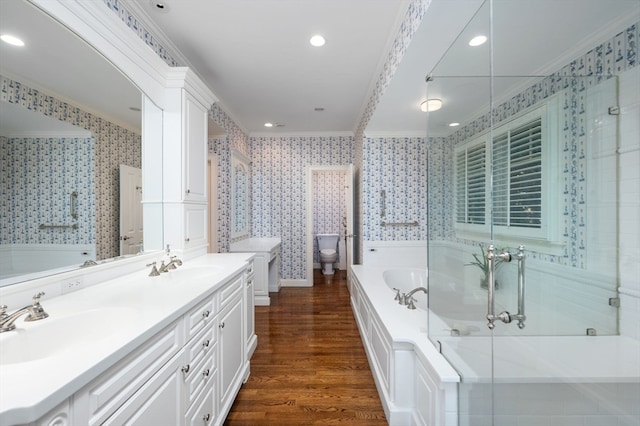 full bathroom featuring crown molding, hardwood / wood-style floors, shower with separate bathtub, toilet, and vanity