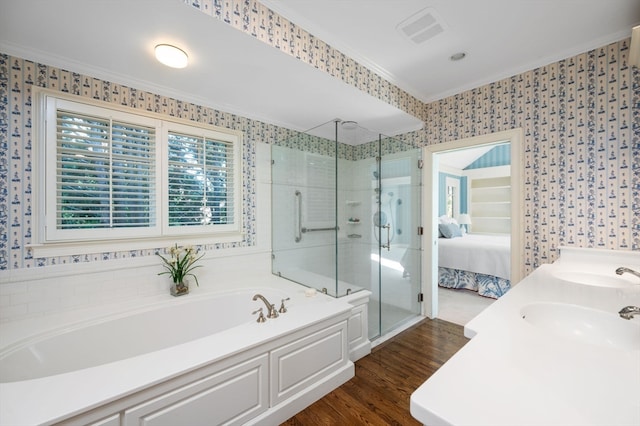 bathroom with vanity, crown molding, hardwood / wood-style floors, and plus walk in shower