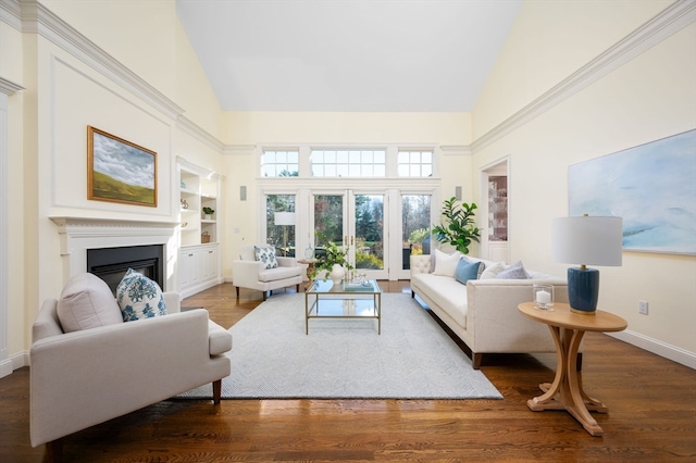 living room with built in shelves, high vaulted ceiling, and hardwood / wood-style flooring