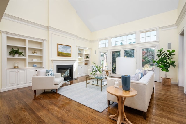 living room with built in features, dark wood-type flooring, and high vaulted ceiling