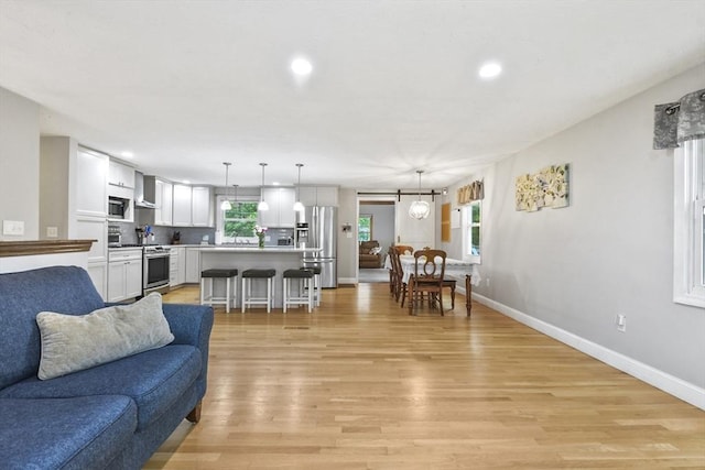 74 S Douglas St, Rockland, MA 02370 - living room with light wood finished floors and recessed lighting