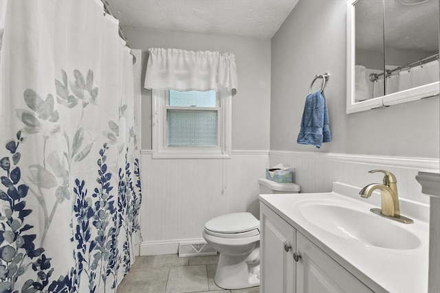 74 S Douglas St, Rockland, MA 02370 - full bathroom with tile patterned floors, vanity, wainscoting, and curtained shower