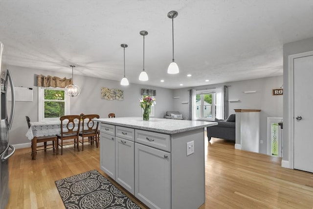 74 S Douglas St, Rockland, MA 02370 - kitchen featuring light wood-style flooring, a kitchen island, pendant lighting, recessed lighting, and plenty of natural light