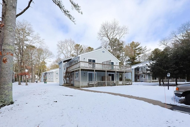 snow covered property featuring a deck