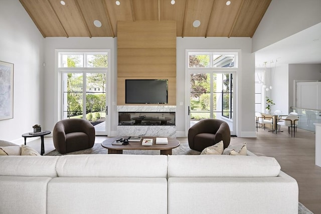 living room with recessed lighting, plenty of natural light, wooden ceiling, high vaulted ceiling, and wood finished floors