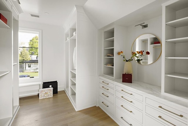 spacious closet with visible vents and light wood-style floors
