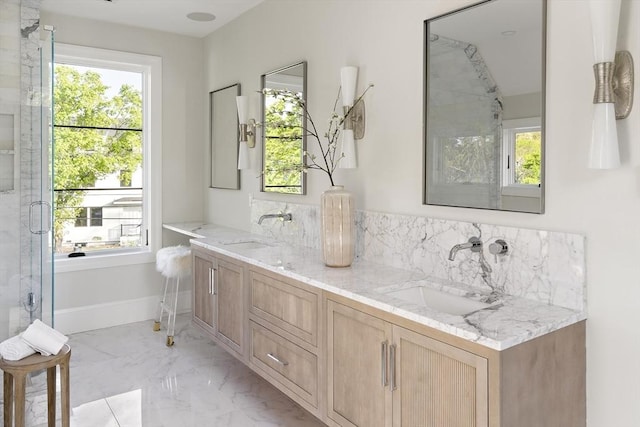bathroom featuring a sink, a wealth of natural light, and backsplash