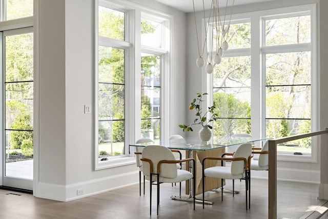 dining space featuring baseboards, visible vents, and wood finished floors