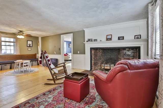 living room with ceiling fan and hardwood / wood-style floors