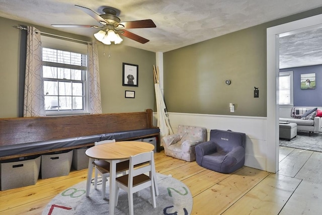 office area with ceiling fan, a healthy amount of sunlight, and light hardwood / wood-style floors