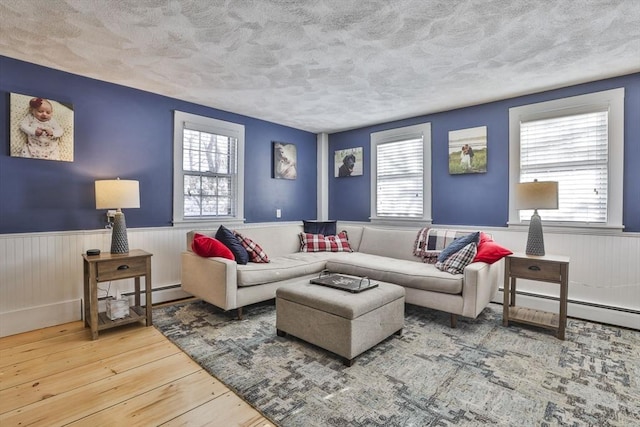 living room with a baseboard radiator and hardwood / wood-style flooring