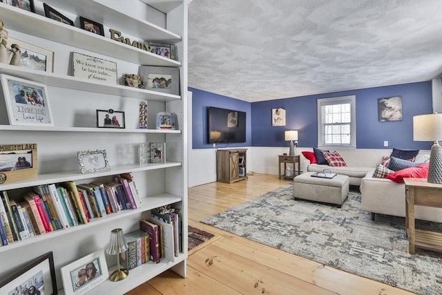 living room featuring a textured ceiling and hardwood / wood-style floors