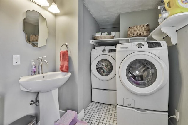 clothes washing area featuring separate washer and dryer