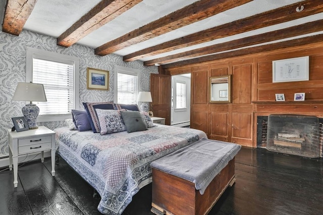 bedroom featuring beam ceiling, dark hardwood / wood-style flooring, and a baseboard radiator