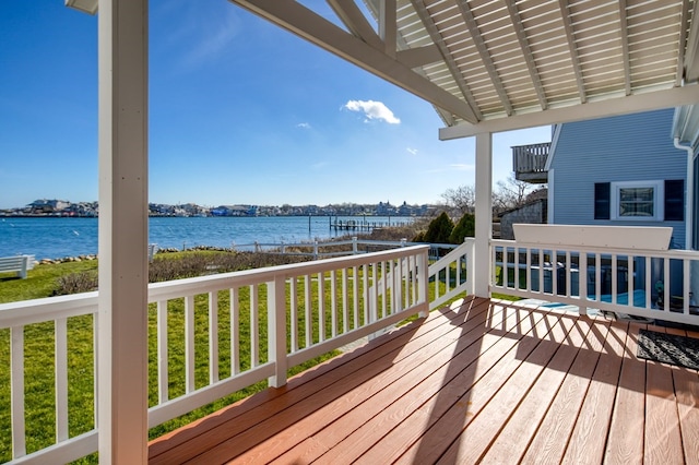 deck featuring a lawn and a water view